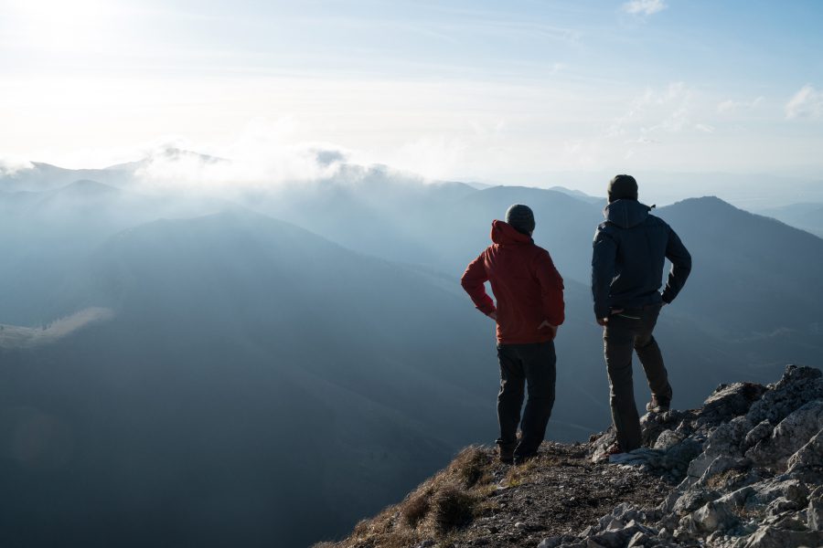 Two hikers standing on a mountain overlook