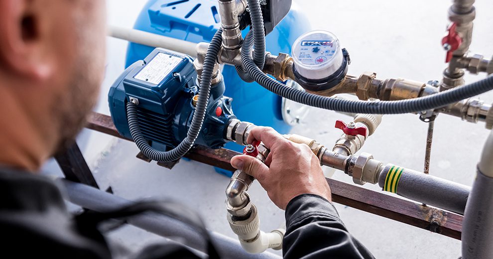 Technician checking water system nodes to help reduce water risk and cost.