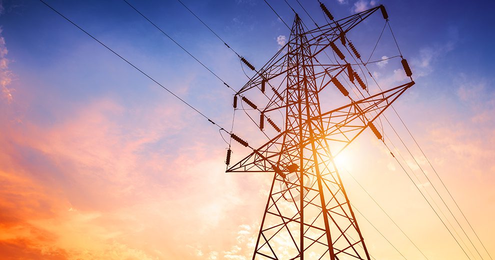 utility transmission wires at sunset