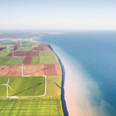 Photo of wind turbines by the sea