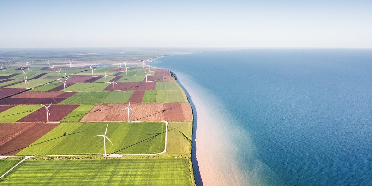 Photo of wind turbines by the sea