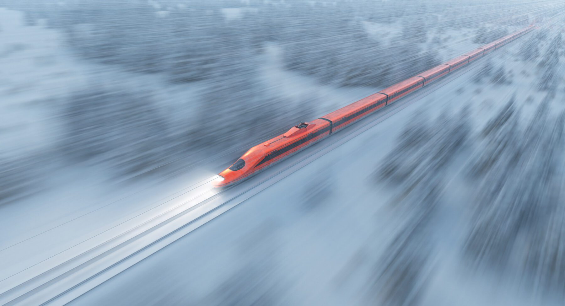 A high speed bullet train zooms through a snow-covered forest during winter, with snowflakes falling heavily. High-speed rail travel in a scenic winter landscape.